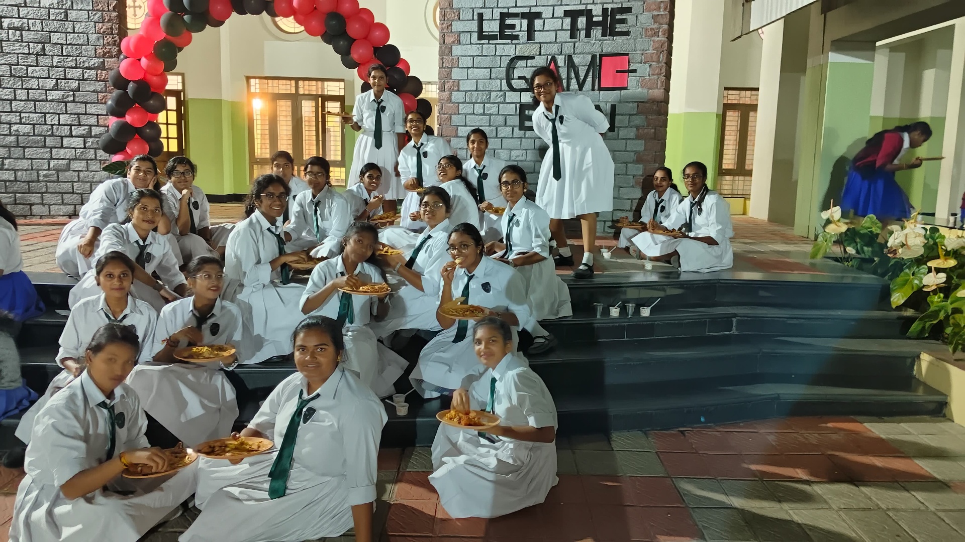 Students enjoying a special celebration with pizza in the school hall
