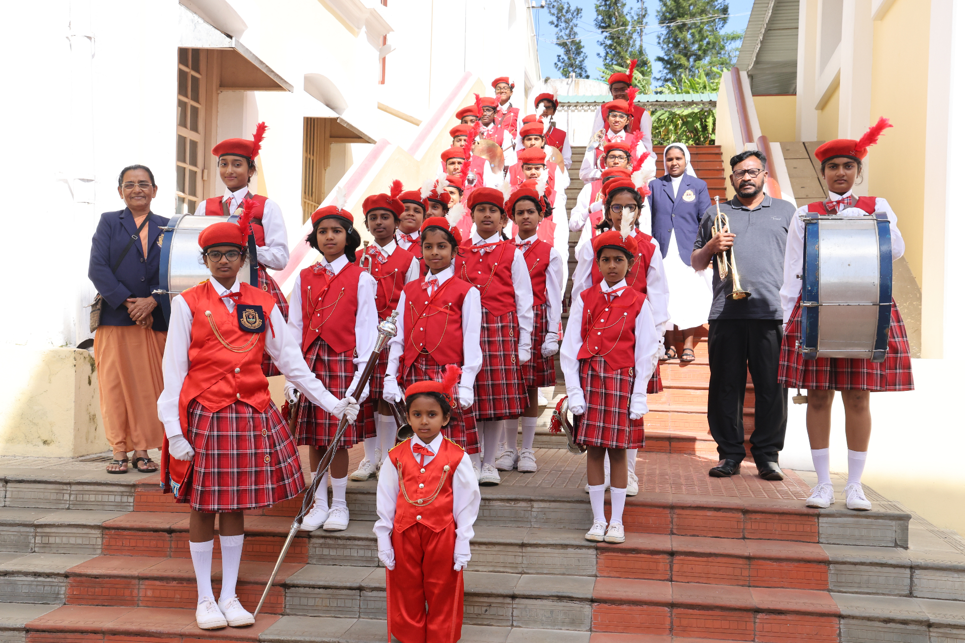 School band in traditional red uniforms during a ceremonial performance