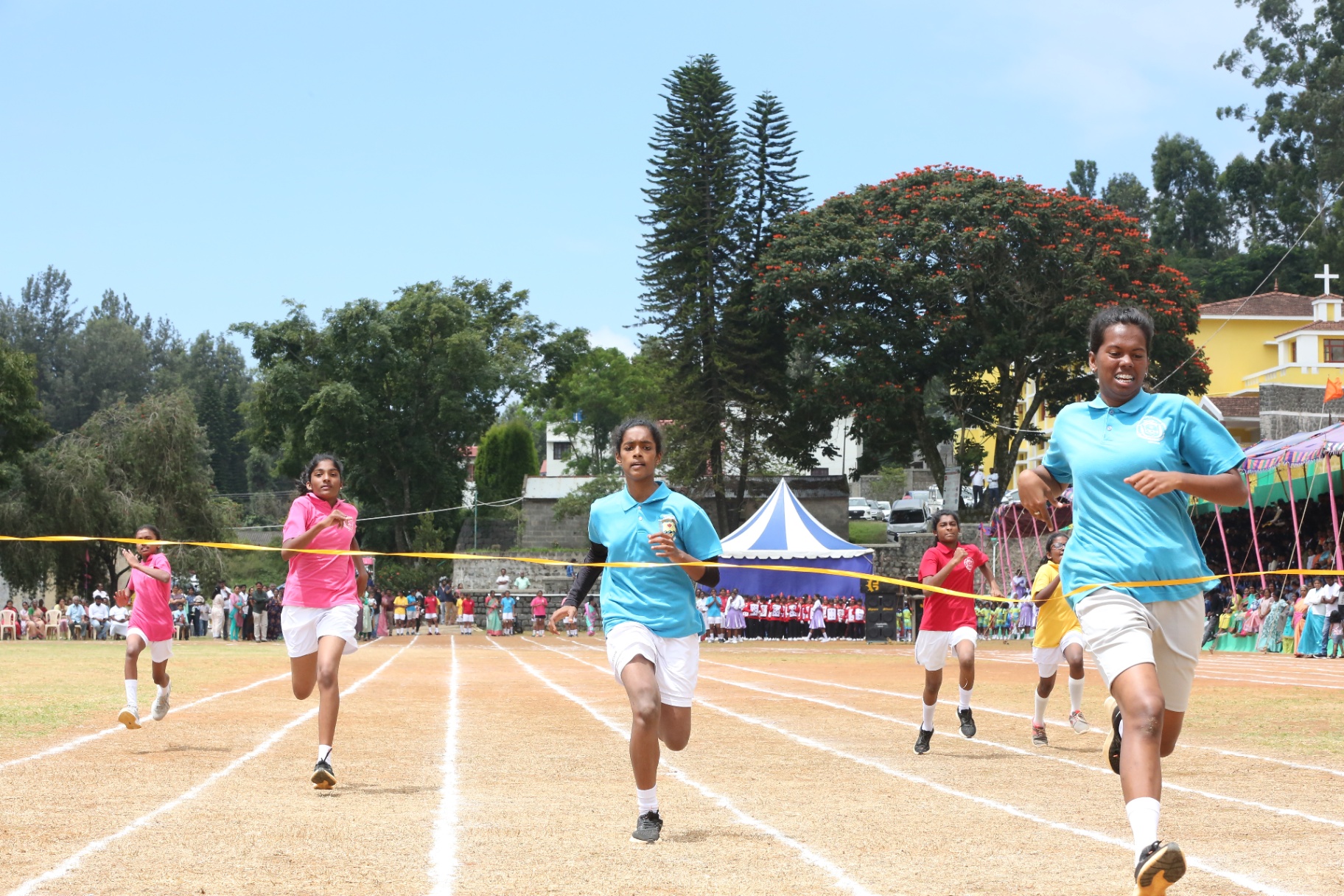 Athletes competing in track and field events on sports day